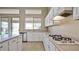 Bright kitchen with tile flooring, white cabinets, a kitchen island and stainless steel appliances at 6923 W Laredo St, Chandler, AZ 85226