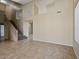 Spacious living room with tile flooring, staircase, neutral colored walls, high ceilings and natural light at 6923 W Laredo St, Chandler, AZ 85226
