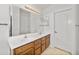 Bathroom featuring a double sink vanity, ample lighting, and white cabinets at 742 E Lovegrass Dr, San Tan Valley, AZ 85143