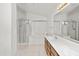 Bathroom featuring dual sinks, wood cabinets, a separate tub, and a glass enclosed shower at 742 E Lovegrass Dr, San Tan Valley, AZ 85143