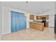Open kitchen and dining area featuring tile floors, wood cabinets, and a hanging light fixture at 742 E Lovegrass Dr, San Tan Valley, AZ 85143