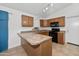 Cozy kitchen with wood cabinets, black appliances, breakfast bar, and recessed lighting at 742 E Lovegrass Dr, San Tan Valley, AZ 85143