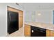 Kitchen showcases a black refrigerator and dishwasher, complemented by wood cabinets and an island at 742 E Lovegrass Dr, San Tan Valley, AZ 85143