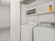 Laundry room featuring a washer and dryer, shelving, and storage space at 742 E Lovegrass Dr, San Tan Valley, AZ 85143