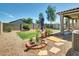 Well-kept backyard with patio, shed, garden, desert landscaping, and block wall fence at 8140 W Lane Ave, Glendale, AZ 85303