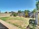 Spacious backyard features a well-maintained lawn, stone landscaping, and a block wall fence at 8140 W Lane Ave, Glendale, AZ 85303