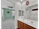 Bathroom with double sinks, a large mirror, and a view to the bedroom at 8140 W Lane Ave, Glendale, AZ 85303