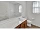 Clean bathroom features a vanity with wood cabinets, a white countertop, and a large mirror at 8140 W Lane Ave, Glendale, AZ 85303