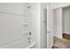 Modern bathroom features a tub with shower, white walls, and stylish fixtures at 8140 W Lane Ave, Glendale, AZ 85303