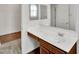 Bathroom featuring wood cabinets, white countertop, a large mirror, and stylish fixtures at 8140 W Lane Ave, Glendale, AZ 85303