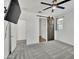 Bright bedroom with a barn door, ceiling fan, and a mounted TV at 8140 W Lane Ave, Glendale, AZ 85303