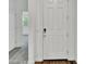 Entryway with a white door, hardwood floors, and a view into the living room at 8140 W Lane Ave, Glendale, AZ 85303
