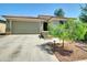 Inviting one-story house with a spacious driveway and well-maintained desert front yard at 8140 W Lane Ave, Glendale, AZ 85303