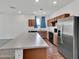 Spacious kitchen with a stainless steel refrigerator, wood cabinets, and a large island at 8140 W Lane Ave, Glendale, AZ 85303