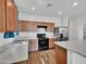 Modern kitchen with stainless steel appliances, wood cabinets, and a breakfast bar at 8140 W Lane Ave, Glendale, AZ 85303