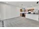 Open-concept living room and kitchen area with modern appliances and a breakfast bar at 8140 W Lane Ave, Glendale, AZ 85303