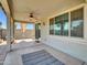 Covered outdoor patio with a ceiling fan and stucco wall at 8140 W Lane Ave, Glendale, AZ 85303