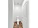 Small powder room with a toilet and wood-look flooring and white door at 8140 W Lane Ave, Glendale, AZ 85303