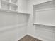 Clean walk-in closet with shelves and rods for organization at 8140 W Lane Ave, Glendale, AZ 85303