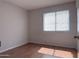 Bedroom with wood floors and a large window at 8308 W Baxter Dr, Phoenix, AZ 85037