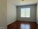 Cozy bedroom with wood floors and a window with blinds at 8308 W Baxter Dr, Phoenix, AZ 85037
