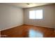 Large bedroom with wood flooring, bright natural light, and neutral decor at 8308 W Baxter Dr, Phoenix, AZ 85037