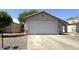 Single-story home featuring a two-car garage with a desert landscape at 8308 W Baxter Dr, Phoenix, AZ 85037