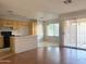 Open kitchen features wooden cabinets, tile floor, and island with sink at 8308 W Baxter Dr, Phoenix, AZ 85037