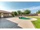 This backyard features a pool, grassy area, and patio area at 8532 E San Bruno Dr, Scottsdale, AZ 85258