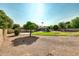 Expansive backyard featuring a pool, green grass and pergola, perfect for outdoor entertaining and relaxation at 8532 E San Bruno Dr, Scottsdale, AZ 85258