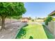Backyard with a grassy area, a pergola, and mature trees for shade at 8532 E San Bruno Dr, Scottsdale, AZ 85258