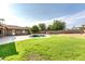Large backyard featuring a pool, pergola, and grassy area at 8532 E San Bruno Dr, Scottsdale, AZ 85258
