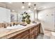 Bright bathroom features a double sink vanity with tile countertops and hanging lights at 8532 E San Bruno Dr, Scottsdale, AZ 85258