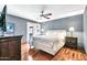 Spacious bedroom with hardwood floors, ceiling fan, and French doors leading to a patio, creating a bright and airy retreat at 8532 E San Bruno Dr, Scottsdale, AZ 85258