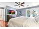 Serene bedroom with a TV, ceiling fan, and French doors to the patio, designed for relaxation and entertainment at 8532 E San Bruno Dr, Scottsdale, AZ 85258