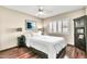 Cozy bedroom featuring a queen bed, wood floors, plantation shutters, and stylish decor for a relaxing and inviting space at 8532 E San Bruno Dr, Scottsdale, AZ 85258