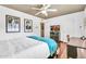 Bedroom with an Ansel Adams print, ceiling fan, and modern decor, creating a tranquil and artistic living space at 8532 E San Bruno Dr, Scottsdale, AZ 85258