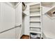 Walk-in closet featuring built-in shelving and hanging rods for storage at 8532 E San Bruno Dr, Scottsdale, AZ 85258