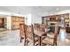 Dining area featuring wood table, view to the living room, and custom wood storage at 8532 E San Bruno Dr, Scottsdale, AZ 85258