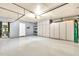 Spacious garage featuring storage cabinets and door to outside at 8532 E San Bruno Dr, Scottsdale, AZ 85258