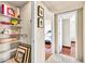 Hallway with storage shelves, wood floors, and views into a sunlit bedroom, offering practical storage and a welcoming feel at 8532 E San Bruno Dr, Scottsdale, AZ 85258