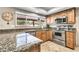 Kitchen featuring stainless steel appliances, granite countertops, tile flooring, and a window overlooking the backyard at 8532 E San Bruno Dr, Scottsdale, AZ 85258