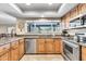The kitchen showcases custom cabinets, granite countertops, stainless steel appliances, and a large window at 8532 E San Bruno Dr, Scottsdale, AZ 85258