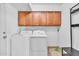 A laundry room featuring a washer, dryer, and storage cabinets at 8532 E San Bruno Dr, Scottsdale, AZ 85258