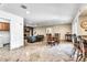 Open floor plan with living room, dining area, kitchen bar, and a beautiful stone fireplace at 8532 E San Bruno Dr, Scottsdale, AZ 85258