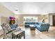 Open-concept living room with large windows, tile floors, stylish furniture, and ample space for relaxing and entertaining at 8532 E San Bruno Dr, Scottsdale, AZ 85258