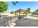 Backyard pergola with seating area, providing a comfortable and shaded retreat next to the pool and green lawn at 8532 E San Bruno Dr, Scottsdale, AZ 85258