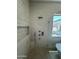 Contemporary shower with built-in niche, sleek fixtures, and neutral stone tiling at 9027 S 19Th St, Phoenix, AZ 85042