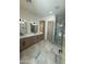 Modern bathroom featuring a double vanity with marble countertops and a glass-enclosed shower at 9027 S 19Th St, Phoenix, AZ 85042