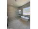 A modern bathroom featuring a soaking tub, glass-enclosed shower, and mountain views at 9027 S 19Th St, Phoenix, AZ 85042